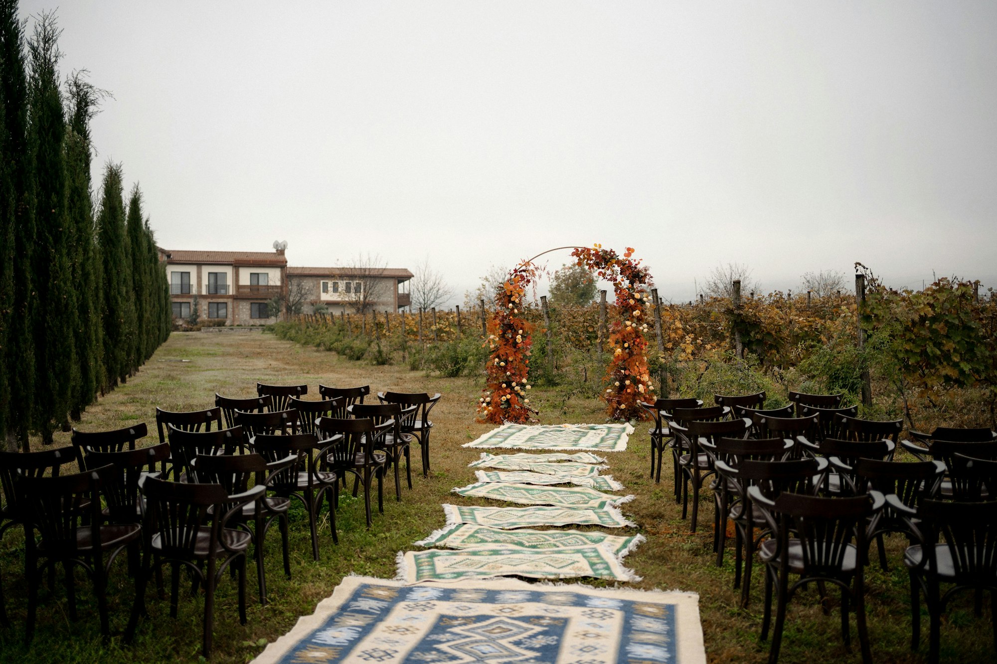 Chairs and rugs set out for an outdoor ceremony before any guests arrive